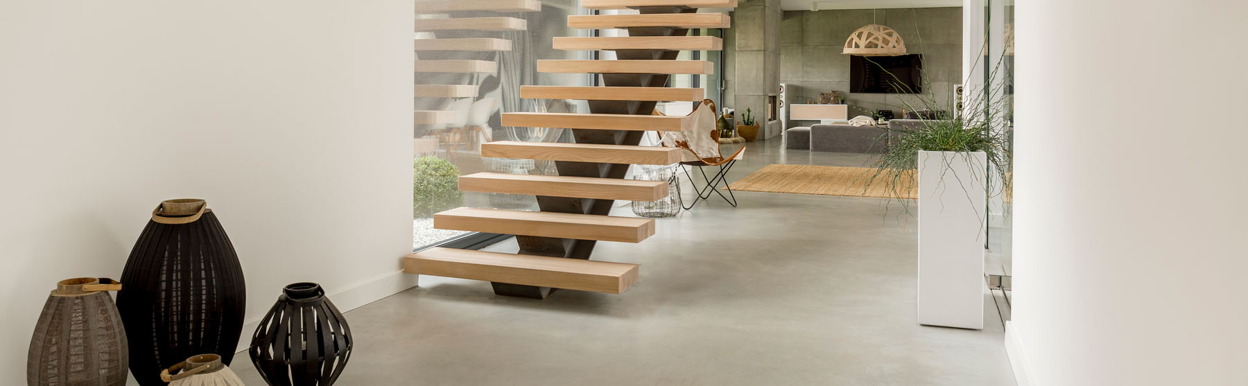 Floating oak staircase on a steel spine in a minimalist open-plan home